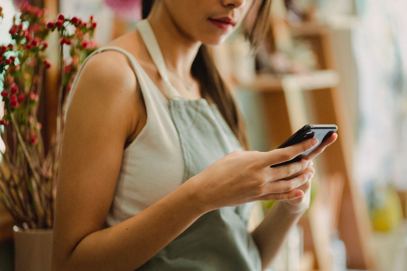 Woman checking a smartphone in a shop