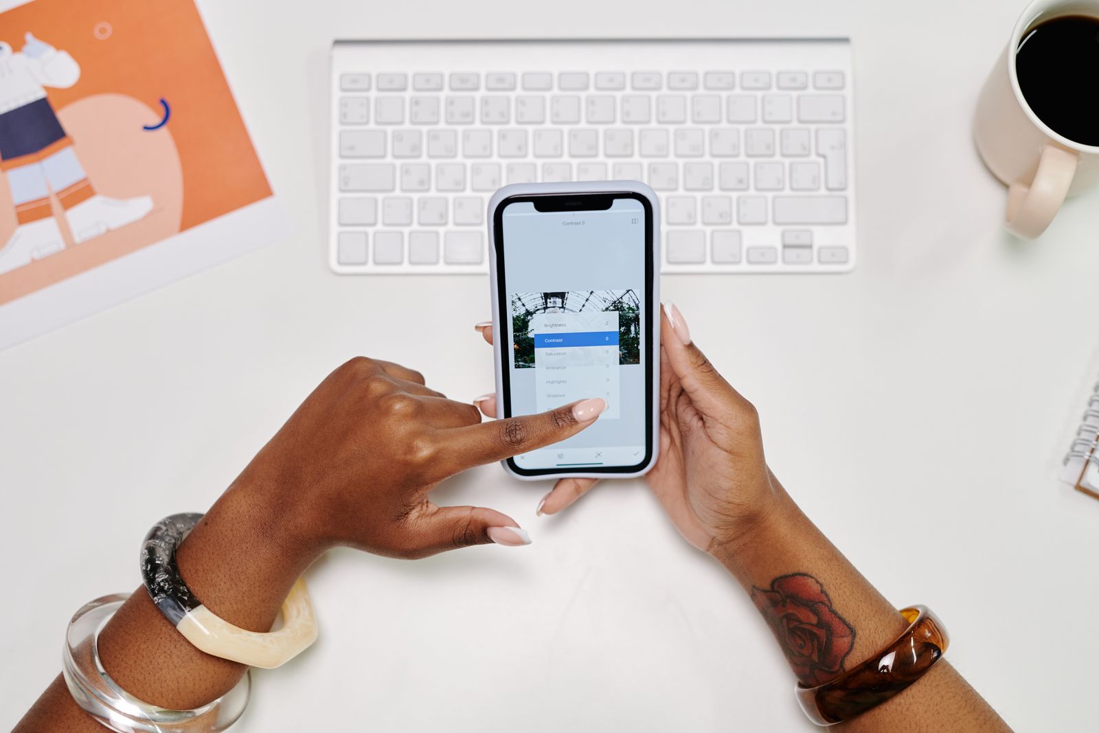Hands using a smartphone at a desk