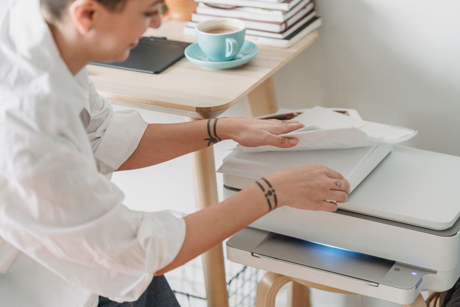Woman loading paper into a home printer