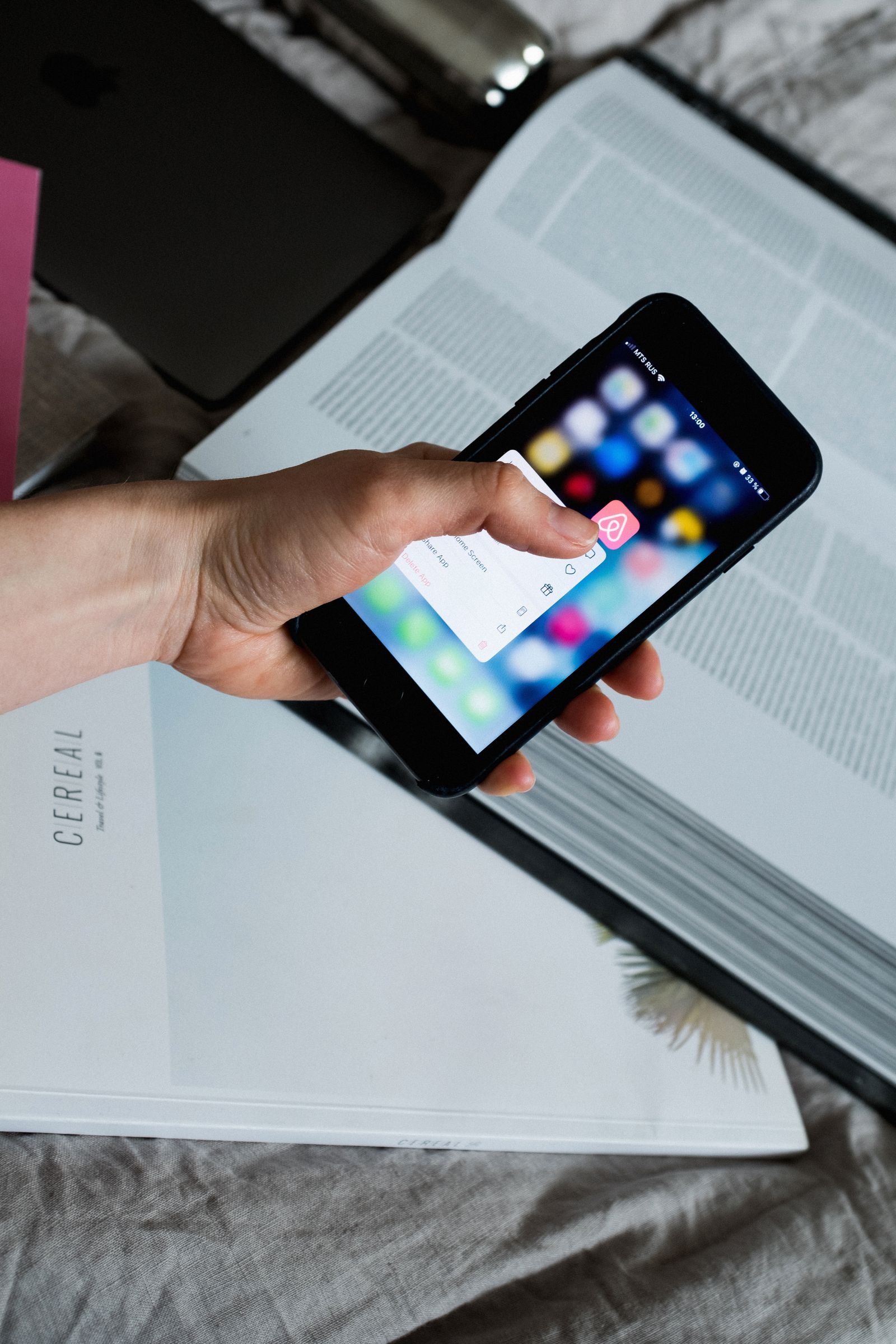 Finger touching a pop-up on a phone screen